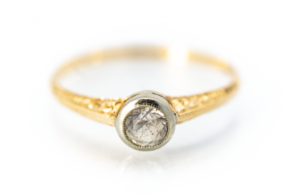 Zlatý prsten s blýskavým kamenem